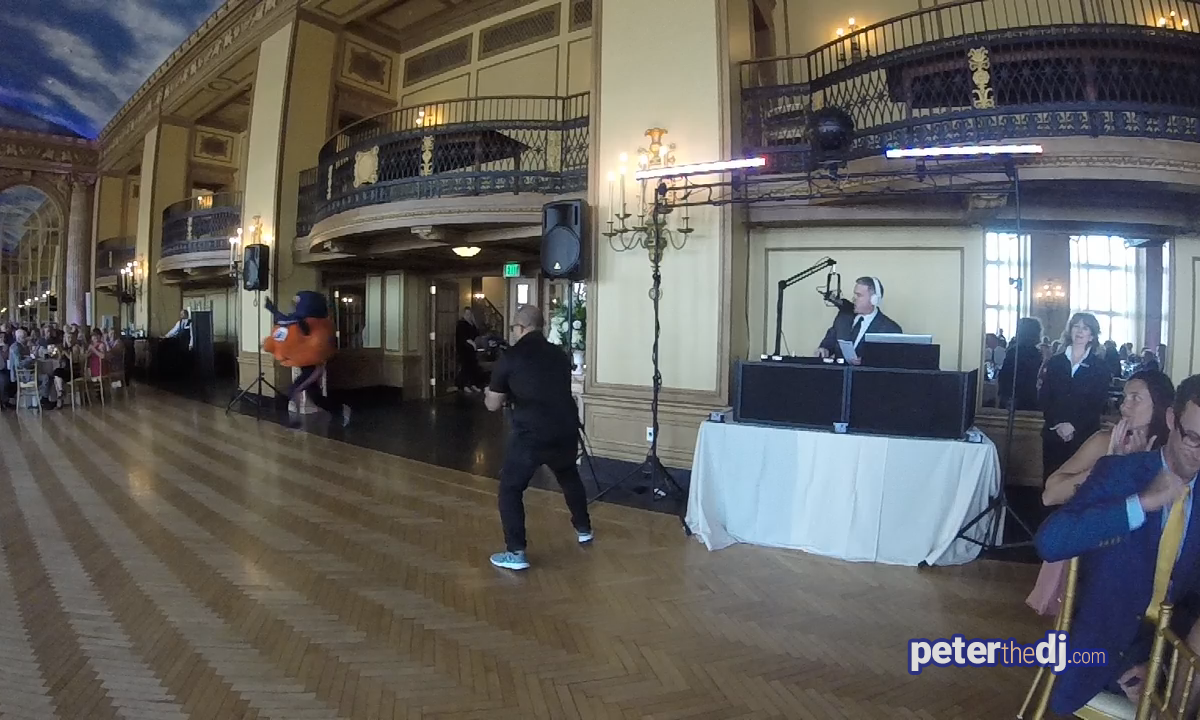 Otto the Orange makes an entrance at Liz and Brian's wedding reception in the Grand Ballroom at the Syracuse Marriott Downtown, July 2019. Photo still from GoPro video by DJ Peter Naughton peterthedj.com